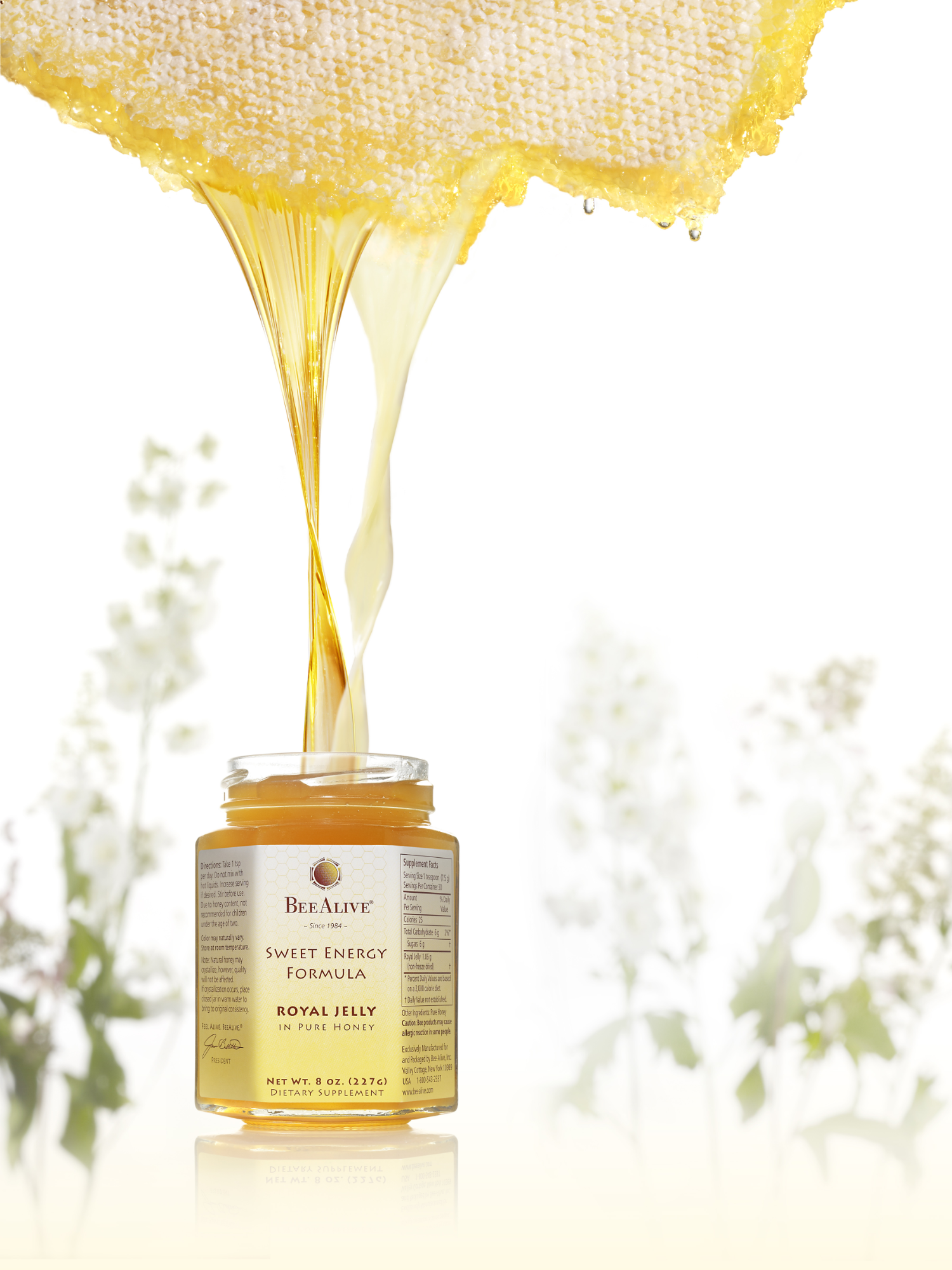 Fresh Royal Jelly poured in golden honey